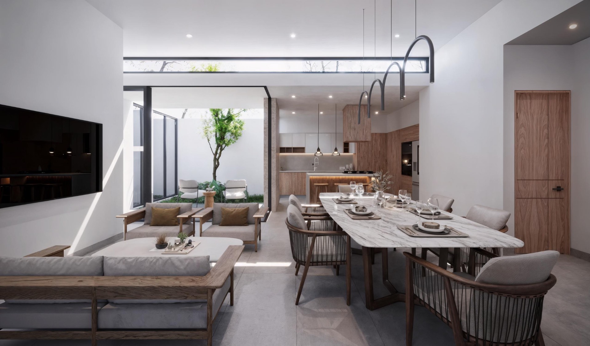 Sala y comedor integrados con doble altura, mesa de mármol y vista a patio interior